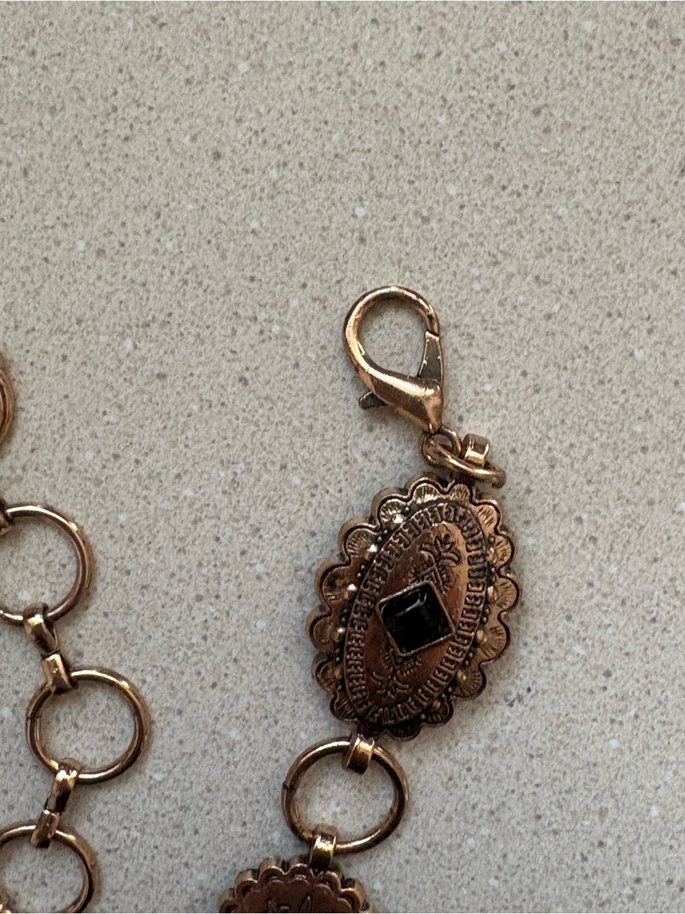Gold-Tone Floral Medallion Charm Bracelet with Black Stone